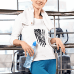 3 4 sleeve t shirt mockup featuring a smiling woman at a gym holding a bottle of water m20349 r el2